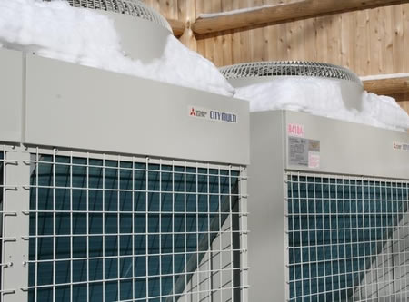 HVAC contractor inspecting a frozen heat pump in Salisbury Mills, NY